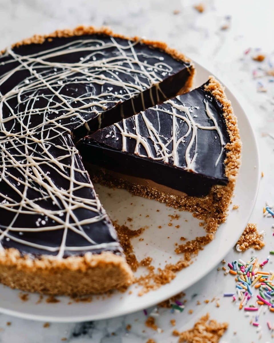 This image shows a dark chocolate pie with three clear layers. The bottom layer is made of a light brown crumbly crust that lines the edge and base of the pie. The middle layer is a thick, smooth, dark black chocolate filling, covering the entire crust. The top is decorated with thin, white lines of icing drizzled randomly to create a web-like pattern. A slice has been removed from the pie, revealing the crust and filling in clear detail. The pie is on a white plate, placed on a white marbled surface with some crumbs and small colorful sprinkles scattered around. Photo taken with an iphone --ar 4:5 --v 7