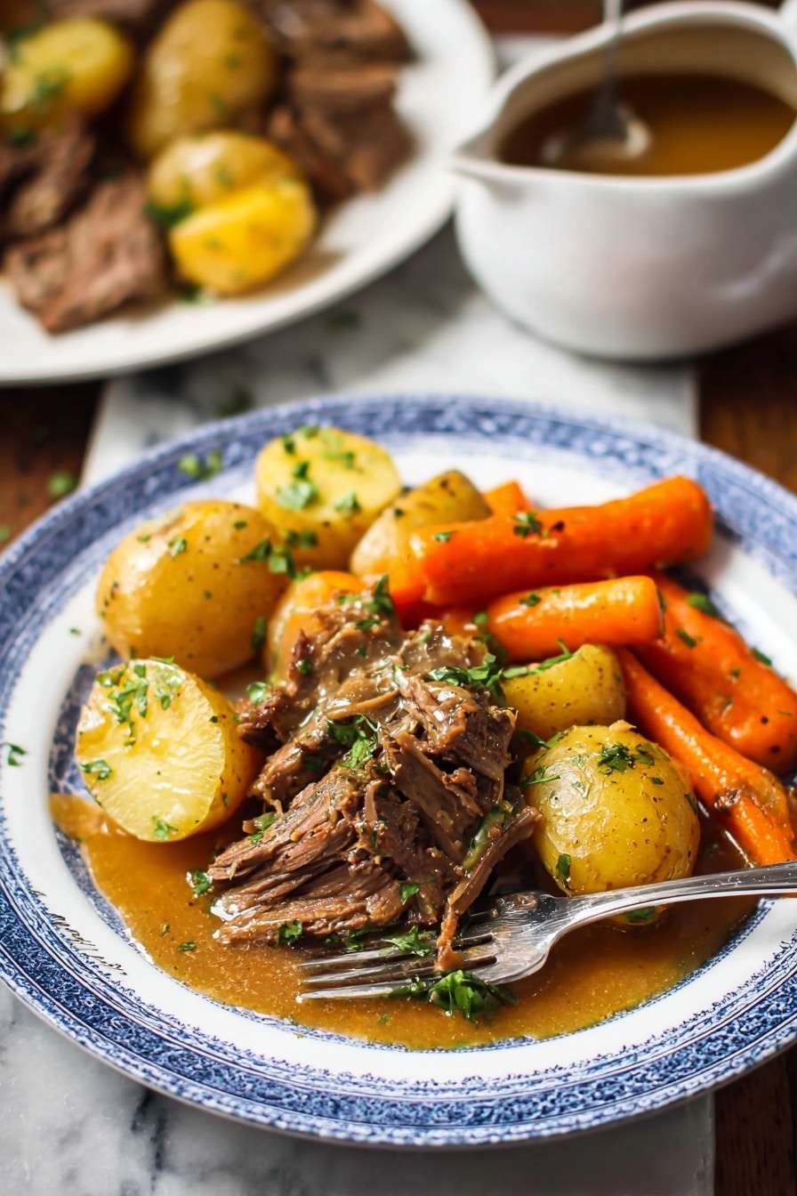 Slow Cooker Pot Roast with Root Vegetables, easy slow cooker pot roast, beef and root vegetable dinner, comforting slow cooker recipes, hearty beef stew - A white plate with a blue rim holds a hearty meal featuring three main layers: golden brown pieces of cooked beef in the center topped with chopped green herbs, tender yellow baby potatoes scattered around the beef, and bright orange carrot sticks positioned near the back. A golden brown sauce with a smooth texture lightly covers parts of the beef and potatoes. A silver fork rests on the plate's edge. In the background, there is a white marbled surface with a blurred white plate containing more beef and potatoes, and a white saucepan with brown sauce on the left side. The overall scene has warm, natural lighting. photo taken with an iphone --ar 2:3 --v 7