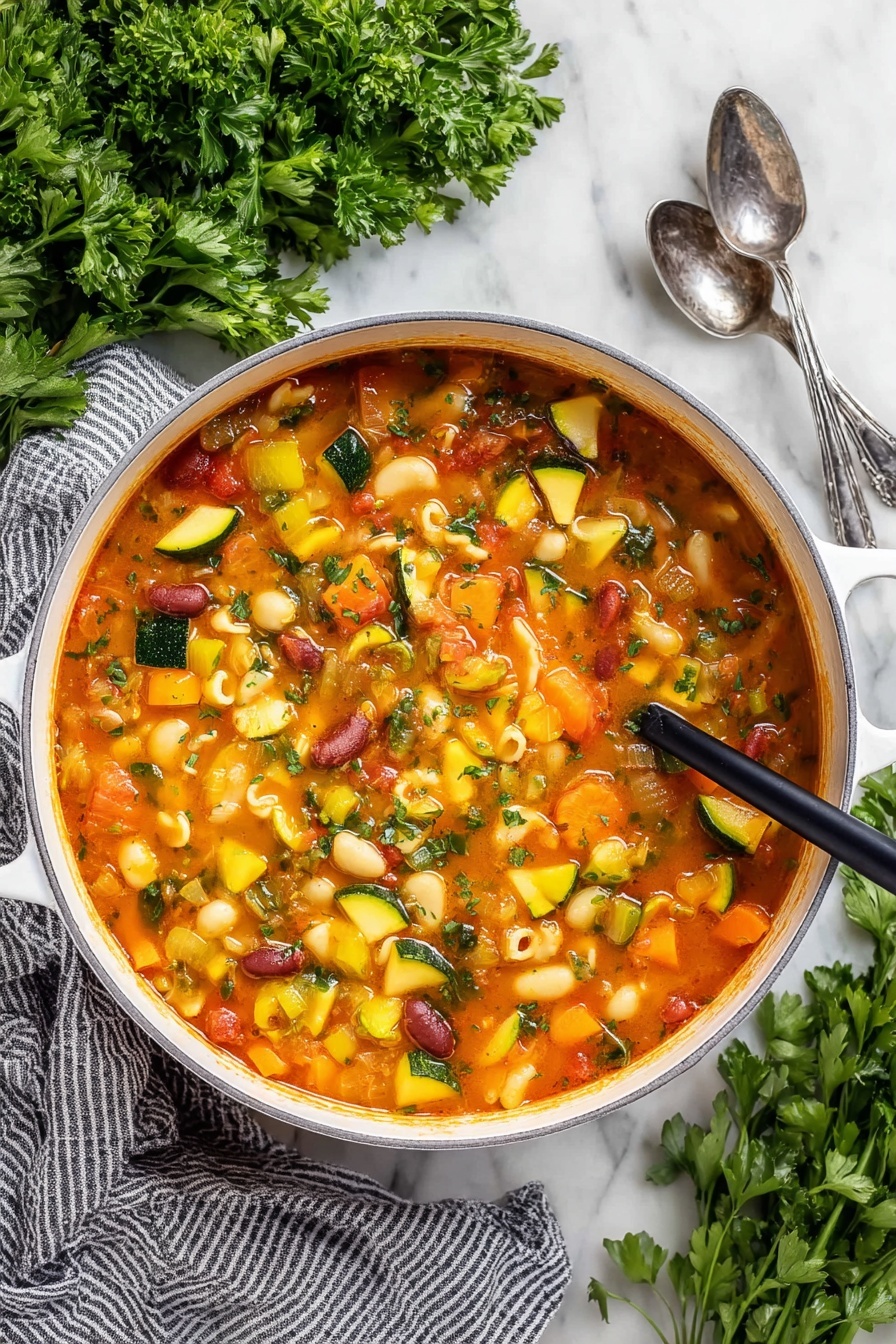 Easy Minestrone Soup, hearty Italian vegetable soup, quick vegetable soup recipe, healthy minestrone, comforting veggie soup - A close-up view of a white pot filled with a thick vegetable soup, showing many soft, colorful chunks. The soup has a reddish-orange broth and contains yellow squash, green zucchini slices, orange carrots, celery, red kidney beans, and small shell pasta. A dark wooden ladle lifts a scoop of soup with mixed vegetables and shells, highlighting the varied textures and colors. The pot sits on a white marbled surface with some green herbs blurred in the background, and a woman's hand holding the ladle is slightly visible. Photo taken with an iphone --ar 2:3 --v 7