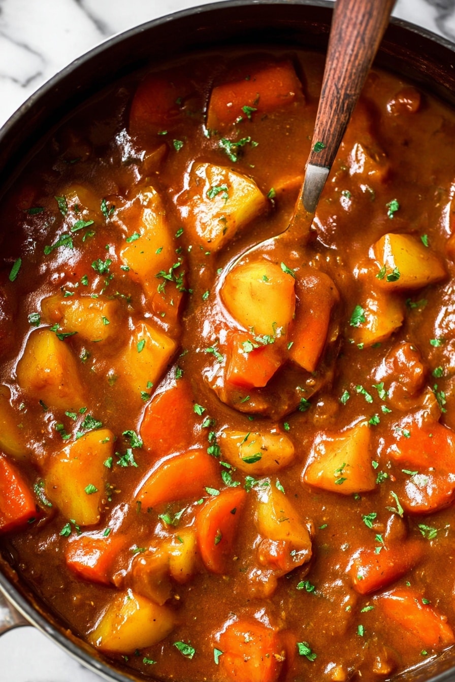 Vegan Irish Stew, Plant-Based Irish Stew, Vegan Irish Stew Recipe, Vegan Hearty Stew, Irish Stew without Meat - The image shows a thick stew in a large pan filled with chunky vegetables including bright orange carrot slices and yellow potato pieces. The stew sauce is rich brown and glossy, spread evenly around the vegetables. Small green herb pieces sprinkle the top, adding a fresh contrast to the warm tones. A spoon sinks into the stew, lifting some of the colorful vegetables, making the texture appear smooth and hearty. The background surface is a white marbled texture. photo taken with an iphone --ar 2:3 --v 7