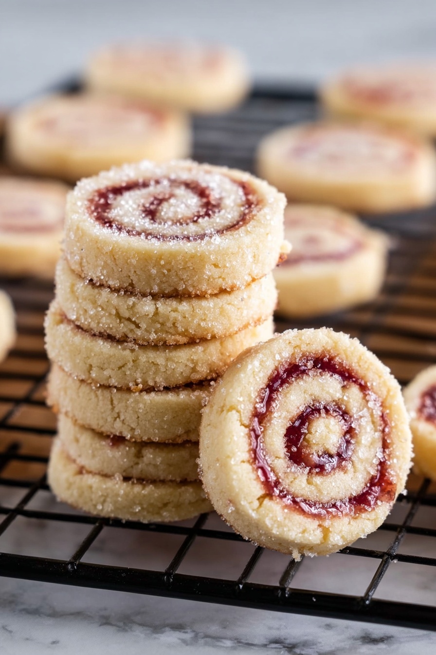 Raspberry Pinwheel Cookies, raspberry swirl cookies, buttery swirl cookies, festive holiday cookies, walnut jam cookies - The image shows a stack of six small round pinwheel cookies with swirls of light beige dough and pinkish-red jam in the center. The cookies are dusted with sparkling sugar crystals on top, giving a slightly rough texture. One cookie leans against the stack, revealing its spiral pattern clearly, while several more cookies are spread on a black wire cooling rack in the background. The cookies have a soft, slightly crumbly texture, and the scene is set on a white marbled surface. Photo taken with an iphone --ar 2:3 --v 7