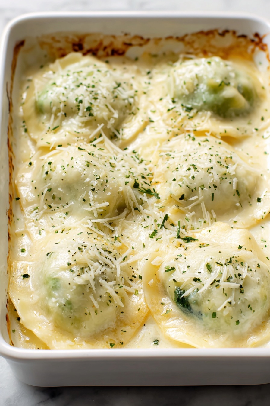 Chicken Alfredo Zucchini Roll Ups, low carb zucchini roll ups, healthy chicken Alfredo, creamy zucchini roll ups, easy zucchini roll ups recipe - A white rectangular baking dish filled with six pieces of ravioli covered in a creamy, pale yellow cheese sauce. Each ravioli is plump and slightly puffy, with edges peeking through the sauce, showing soft green filling inside. The top is sprinkled with finely grated light yellow cheese and small green herb flakes, giving a fresh look. The sauce looks smooth and slightly thick, spread evenly all over the ravioli. The edges of the baking dish have a bit of golden brown crust. All of this is placed on a white marbled surface. Photo taken with an iphone --ar 2:3 --v 7