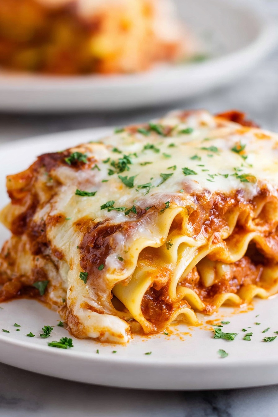 Cheesy Beef Lasagna Roll-Ups, easy baked lasagna roll-ups, cheesy beef pasta, homemade lasagna recipes, family-friendly dinner - A rolled lasagna piece sits on a white plate with soft, wavy pasta layers visible on the sides. The lasagna has three layers inside, filled with a mix of rich red tomato sauce and light orange cheese sauce. The top is covered with a thick layer of melted white cheese that has some golden brown spots, sprinkled with small green parsley leaves. The plate is placed on a white marbled surface, and there is a blurred second plate in the background. Photo taken with an iphone --ar 2:3 --v 7