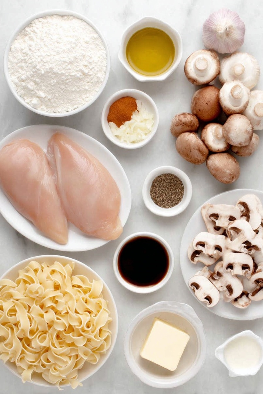 Easy Chicken Stroganoff, Chicken Stroganoff recipe, creamy chicken dinner, quick weeknight chicken, comforting chicken dish - Flat lay of two boneless skinless chicken breasts, a small mound of all-purpose flour in a white ceramic bowl, three whole brown garlic cloves, a small white bowl with olive oil, a pat of butter on a white ceramic dish, a cluster of sliced cremini mushrooms, one small chopped yellow onion on a white plate, a small white bowl of dry mustard powder, a small white bowl of Worcestershire sauce, a small white bowl of chicken broth, a small white bowl of sour cream, a generous nest of fresh egg noodles, salt and freshly ground black pepper in small white bowls, arranged in perfect symmetry and balanced proportions, placed on a clean white marble surface, soft natural light, photo taken with an iPhone, professional food photography style, fresh ingredients, white ceramic bowls, no bottles, no duplicates, no utensils, no packaging --ar 2:3 --v 7 --p m7354615311229779997