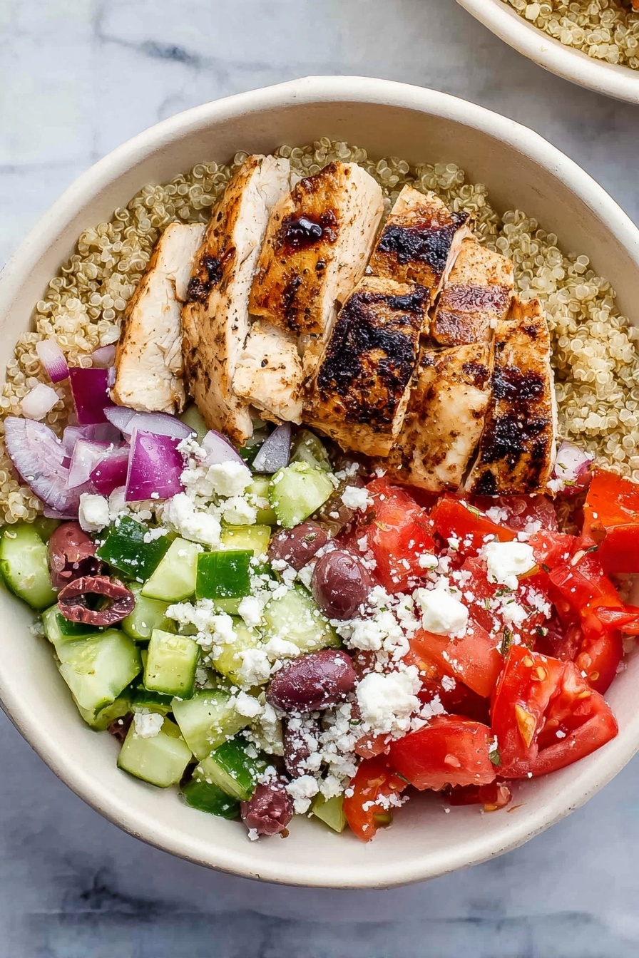 Greek Chicken Quinoa Bowl, Mediterranean chicken quinoa salad, healthy Greek bowl, easy Greek chicken recipe, flavorful quinoa and chicken meal - A white bowl holds a colorful layered dish on a white marbled surface. The bottom layer is light beige quinoa. On top of this, sliced grilled chicken with visible char marks sits to one side. To the right of the chicken is a mix of chopped red tomatoes and small pieces of red onion. Below the tomato mix is chopped green cucumber with some purple olives scattered throughout. White crumbled cheese is sprinkled over the top of the tomatoes, cucumbers, and olives. The colors contrast well, showing fresh and healthy ingredients. Photo taken with an iphone --ar 2:3 --v 7