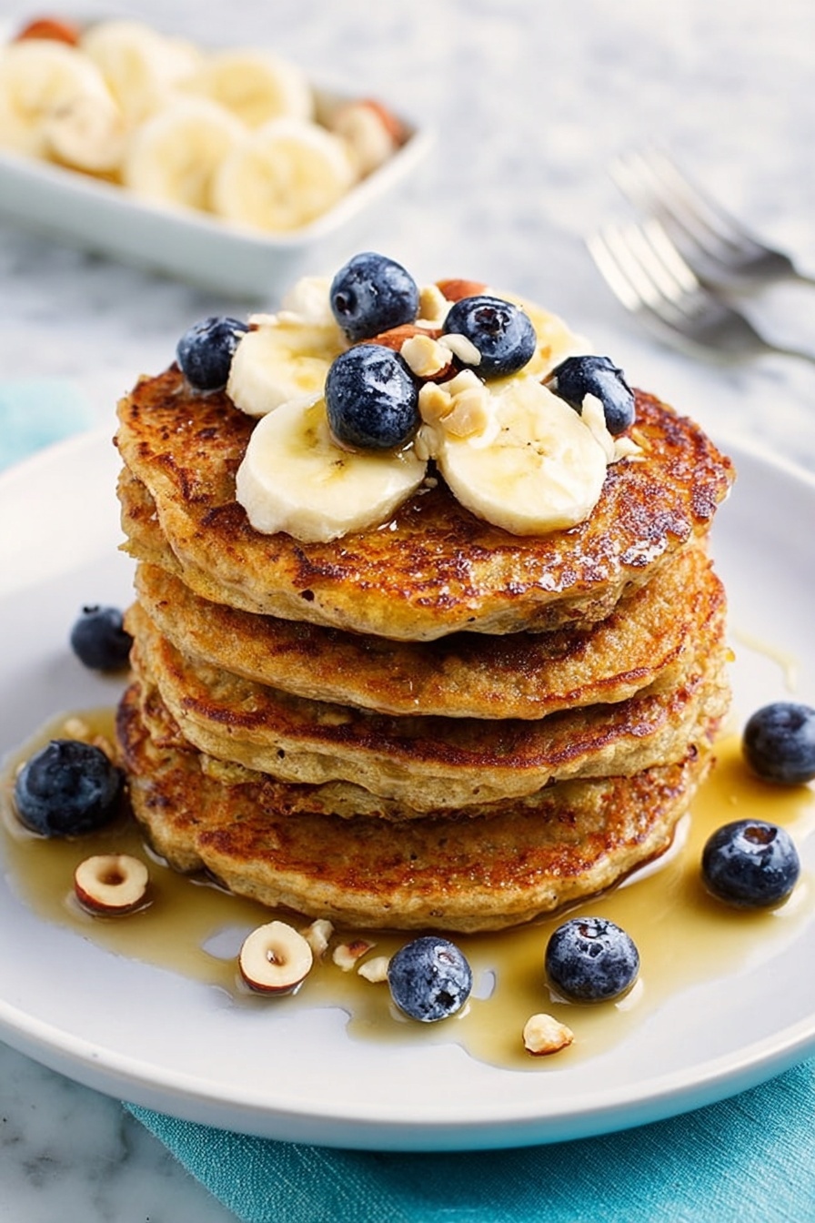 Healthy Banana Oatmeal Pancakes, healthy breakfast ideas, gluten-free pancake recipe, easy nutritious pancakes, vegan oat pancakes - A stack of five thick golden-brown pancakes sits in the center of a white plate on a white marbled surface. The pancakes have a slightly crispy edge and a soft texture visible on the sides. On top, there is a layer of banana slices that are creamy yellow, mixed with small deep blue blueberries and a few light-colored hazelnuts. Honey or syrup drizzles over the top and pools around the base, giving a shiny, sticky finish. More blueberries and hazelnuts are scattered around the plate. In the background, a white dish with banana slices and a fork rest on the white marbled surface. photo taken with an iphone --ar 2:3 --v 7