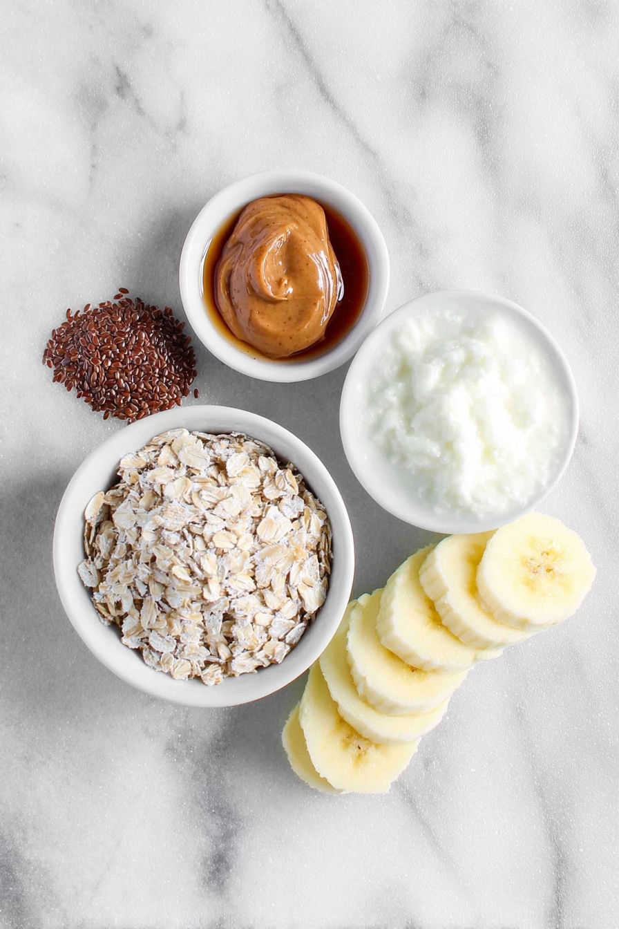 Peanut Butter Banana Overnight Oats, healthy breakfast ideas, easy overnight oats, nutritious morning recipes, quick make-ahead breakfast - Flat lay of a small mound of rolled oats, a teaspoon of whole flax seeds, a light dusting of ground cinnamon beside a small white ceramic bowl of milk, a small white ceramic bowl filled with amber maple syrup, a dollop of creamy peanut butter on the side, and a perfectly ripe half banana sliced into neat pieces arranged next to the ingredients, all placed on a clean white marble surface, soft natural light, photo taken with an iPhone, professional food photography style, fresh ingredients, white ceramic bowls, no bottles, no duplicates, no utensils, no packaging --ar 2:3 --v 7 --p m7354615311229779997