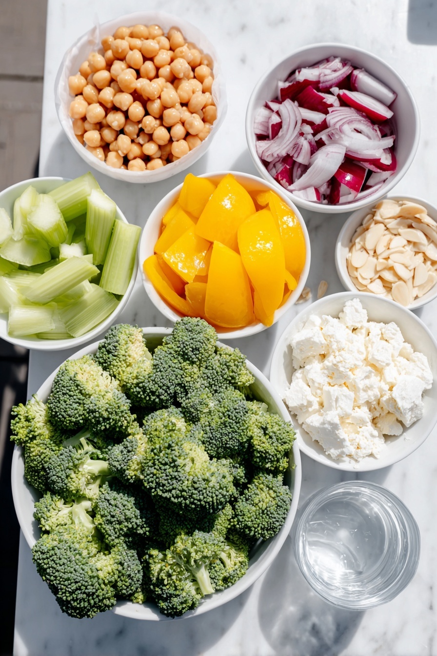 Broccoli Chickpea Salad with Lemon Tahini Dressing, healthy broccoli chickpea salad, lemon tahini dressing recipe, vegan salad ideas, easy veggie salad - Flat lay of fresh chopped broccoli florets, a small white bowl of rinsed chickpeas, bright yellow bell pepper pieces, chopped celery stalks, finely chopped red onion, a small white bowl of slivered almonds, crumbled creamy goat cheese, a small white bowl of smooth tahini, a small white bowl with fresh lemon juice, a whole unpeeled garlic clove, and a small white bowl of clear water placed on a clean white marble surface, soft natural light, photo taken with an iPhone, professional food photography style, fresh ingredients, white ceramic bowls, no bottles, no duplicates, no utensils, no packaging --ar 2:3 --v 7 --p m7354615311229779997